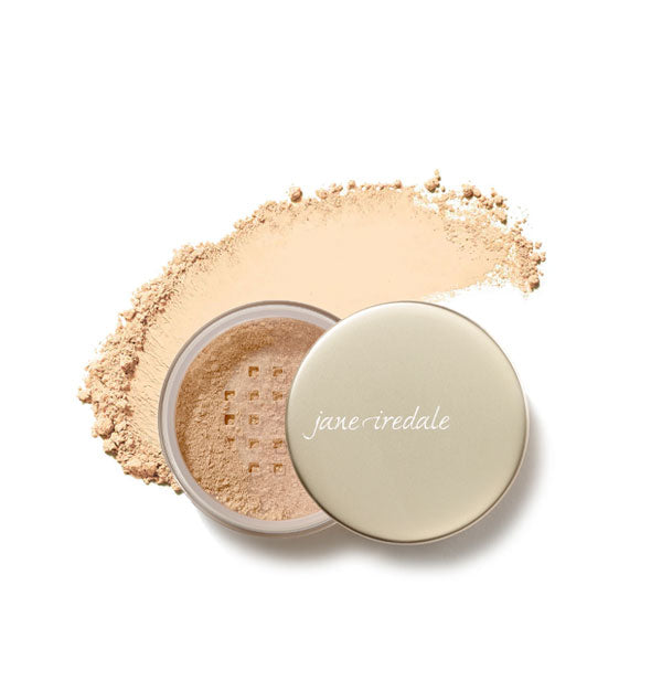 An open compact of Jane Iredale Amazing Matte Loose Finishing Powder overtop a smeared application of product