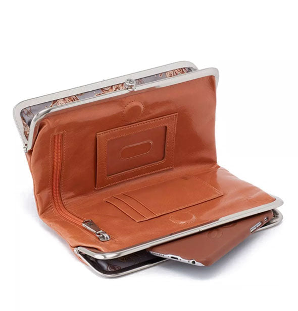 Brown leather wallet propped open to show interior storage compartments