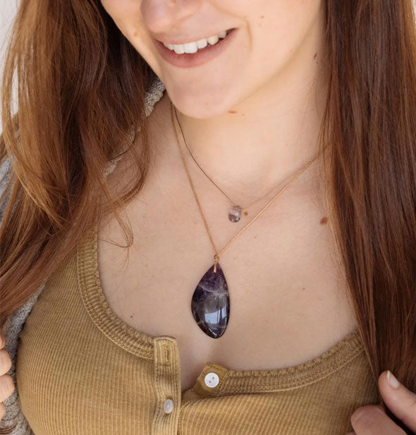 Smiling model wears a purple amethyst stone necklace