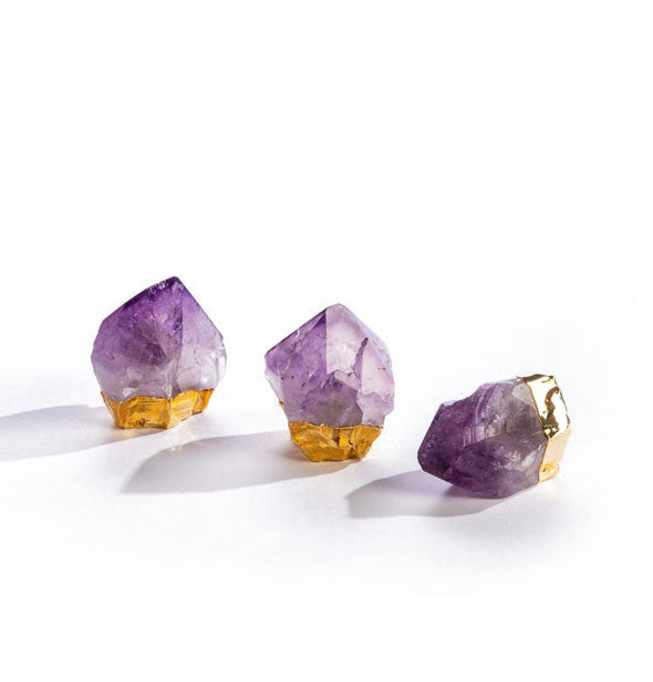 Three purple amethyst crystal points with gold plated bases