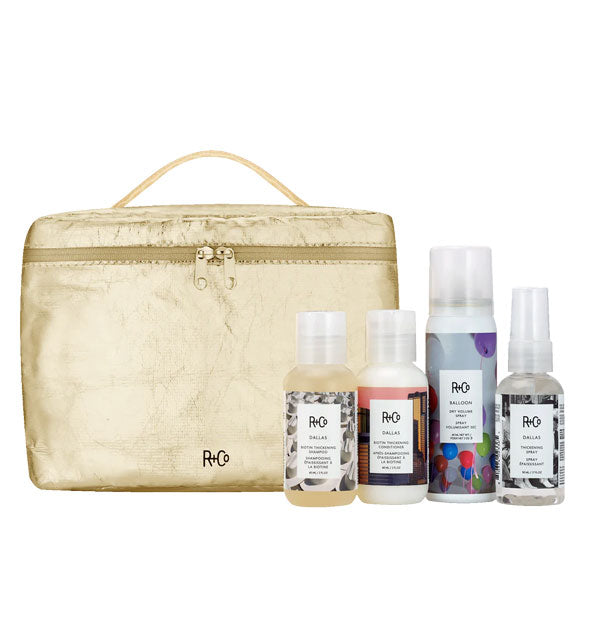 Travel sized R+Co Dallas Biotin Thickening Shampoo, Conditioner, and Spray and Balloon Dry Volume Spray with metallic gold carrying case