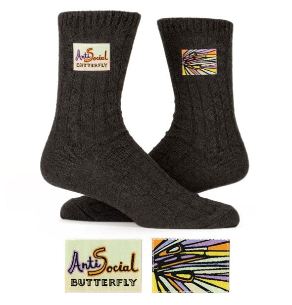 Dark gray socks with colorful sewn-in labels, one of which says, "Antisocial Butterfly"