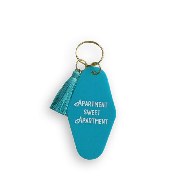 Blue tab keychain on gold hardware with blue tassel says, "Apartment Sweet Apartment" in white lettering