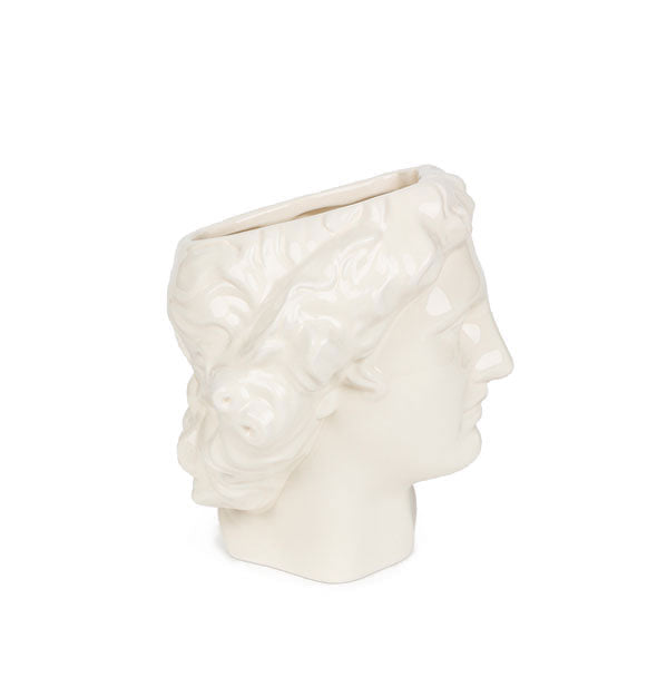 Profile view of white Apollo head vase