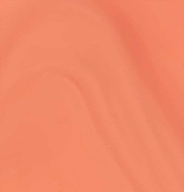 Closeup of pinkish-orange nail polish