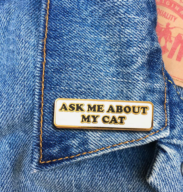 Ask Me About My Cat enamel pin on jean jacket lapel