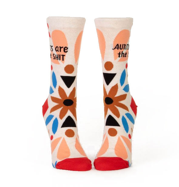 Socks with floral design and red heels and toes say, "Aunts are the shit" in black lettering