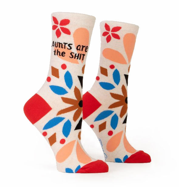 Socks with floral design and red heels and toes say, "Aunts are the shit" in black lettering