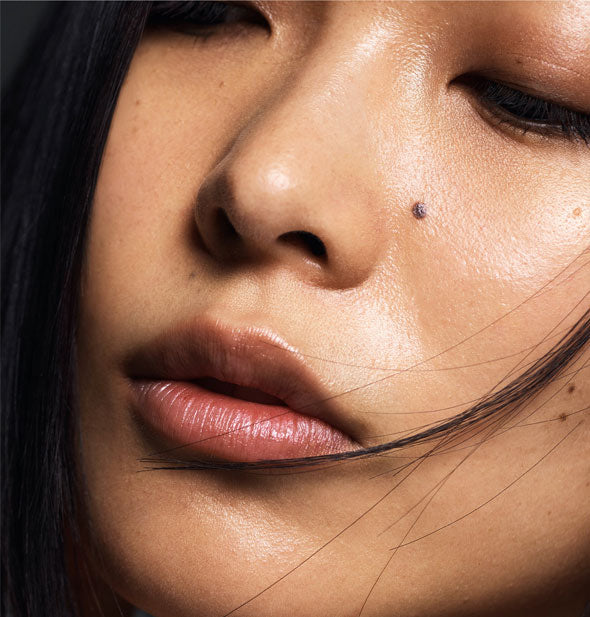 Model's lips are moisturized with a slight sheen