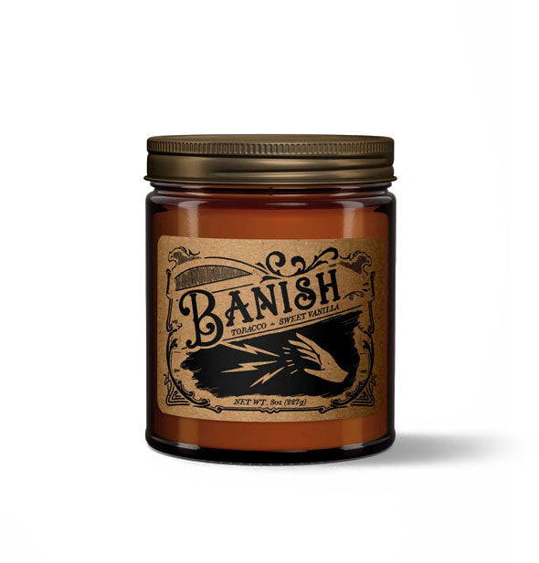 Banish candle in amber glass jar with metal lid features a kraft paper label in a vintage style with spell-casting hand illustration