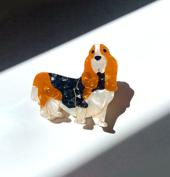 Hair clip with quartz effect is designed and painted to resemble a Basset hound