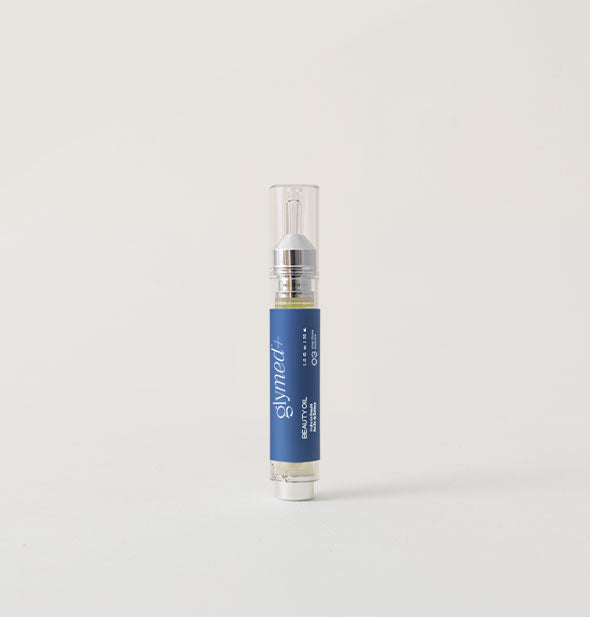 Slender blue tube of GlyMed+ Beauty Oil with silver nozzle and clear cap