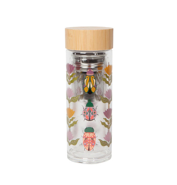 Cylindrical clear glass bottle with print of colorful beetles and flowers has a bamboo lid and internal stainless steel infuser apparatus