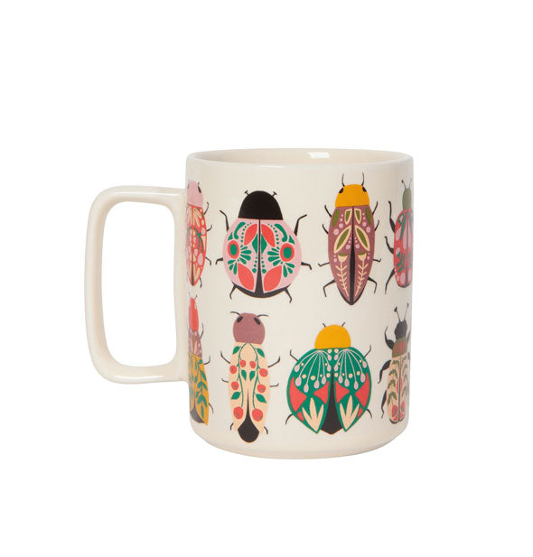 White coffee mug with square handle features all-over colorful and intricate illustrations of beetles and other insects