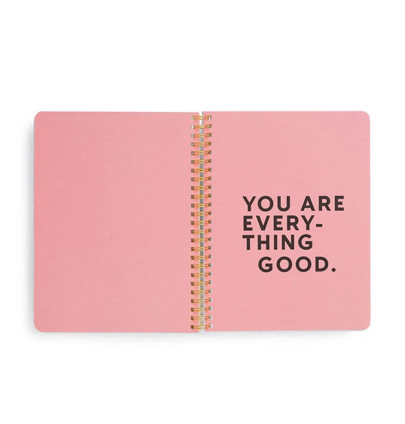 Spiral-bound notebook interior with pink pages says, "You are everything good." on the right-hand side