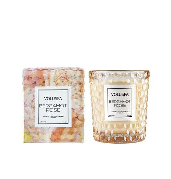 Embossed glass Voluspa Bergamot Rose candle jar next to gift box with pastel rose design