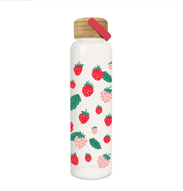 Tall glass water bottle with pink and red strawberry print has a bamboo lid with red handle