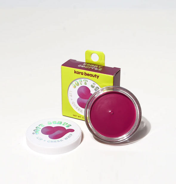 Opened compact of Kara Beauty Soft Serve Lip & Cheek Whip in magenta shade Berry Souffle propped up against its box packaging