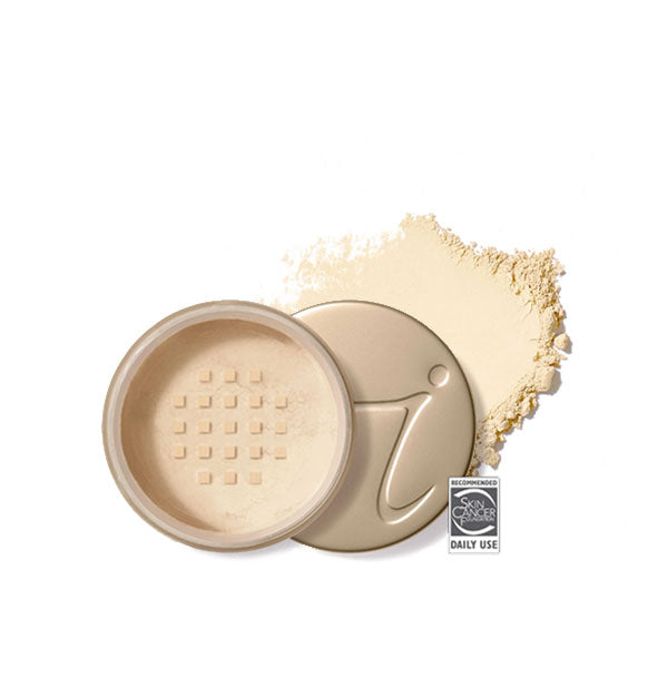 Opened round Jane Iredale loose powder compact with stamped gold lid and product application behind it in shade Bisque