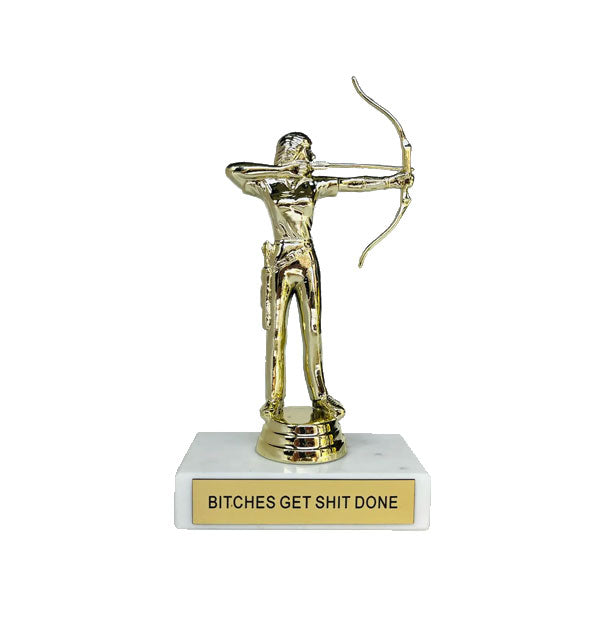 Trophy with gold archer figurine atop a white marble base inscribed with, "Bitches Get Shit Done" on a gold placard