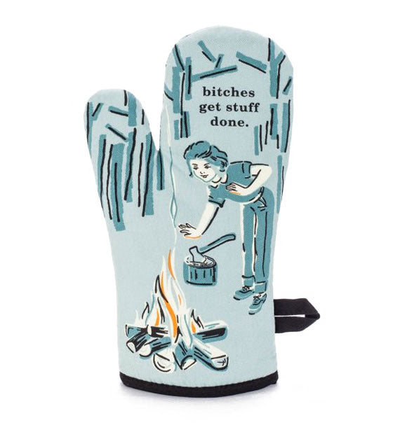 Light blue oven mitt with monochromatic illustration of a woman by a campfire says, "Bitches get stuff done"