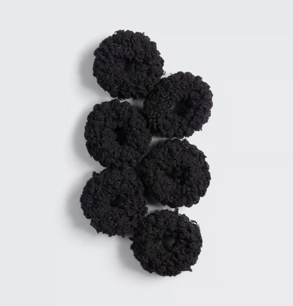 Six black thick fluffy cotton hair scrunchies laid flat