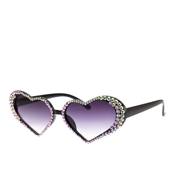 Black heart-shaped sunglasses with rhinestones bordering grayish-blue gradient lenses