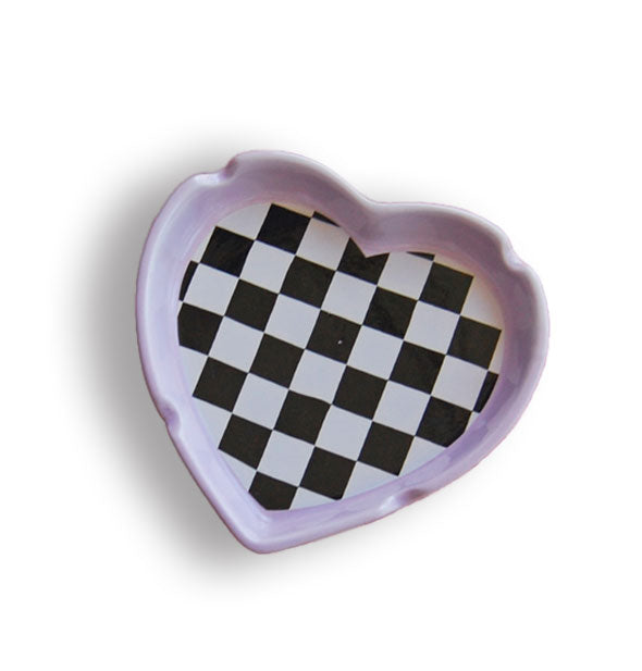 Heart-shaped ashtray with four cigarette notches features a light purple edge and black and white checkerboard print in the bottom