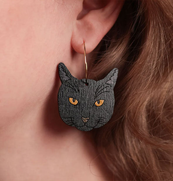 Model wears a black cat face hoop earring