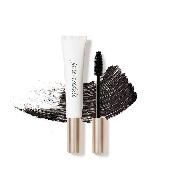 White and gold tube of Jane Iredale Longest Lash Mascara with separate applicator brush and a streak of product behind both in the shade Black Ice