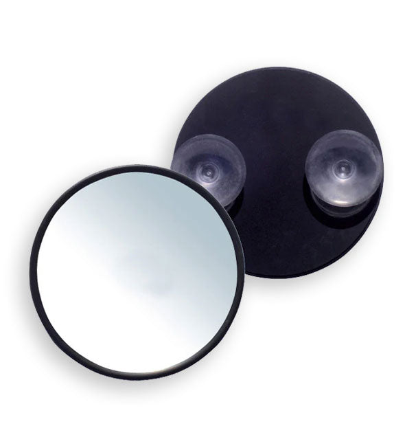 Round black mirror shown from both the front ana back where two suction cups are attached