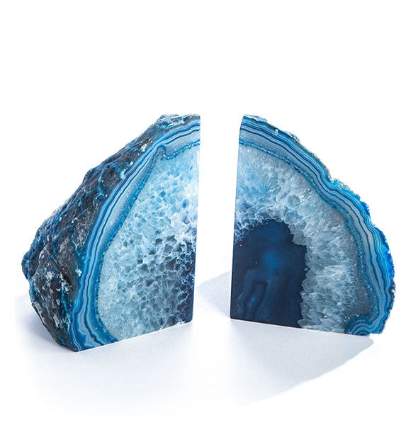 Two blue agate slices with rough exteriors and polished interiors intended for use as bookends