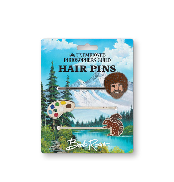 Bob Ross hair pins on The Unemployed Philosophers Guild backer card with mountainous landscape design