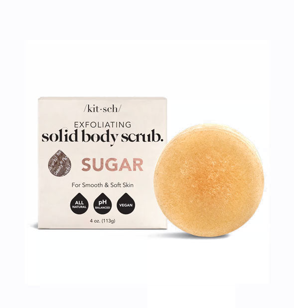 Round amber-colored Solid Body Scrub Sugar bar by Kitsch next to packaging