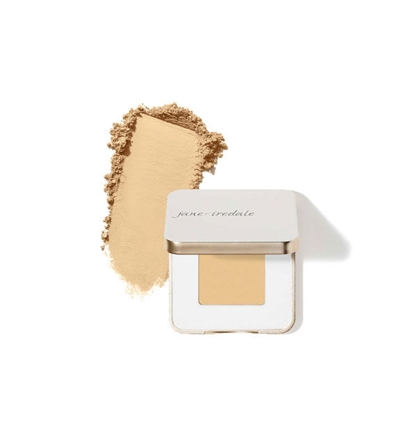 Opened square white and gold Jane Iredale eye shadow compact with sample product application at left in the shade Bone