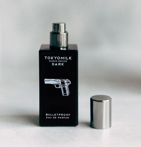 Opened bottle of TokyoMilk Bulletproof Eau de Parfum with silver cap set to the side