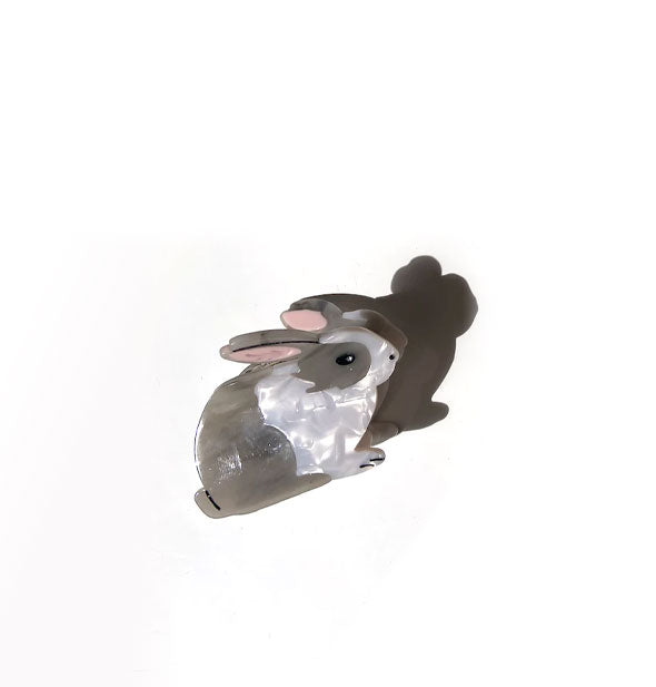 White and beige-gray quartz-effect bunny rabbit hair clip with pink ears and black face, tail, and paw line details