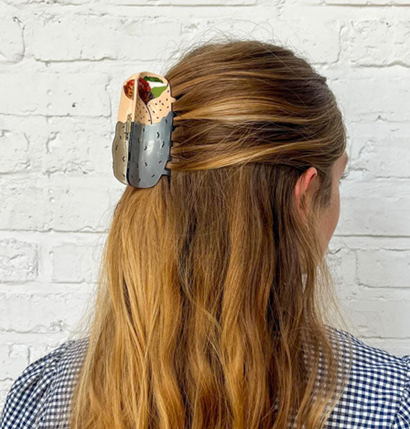 Model wears a hair clip designed to resemble a burrito  partially wrapped in foil