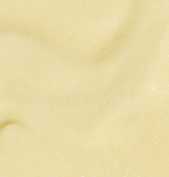 Closeup of shimmery pastel yellow nail polish