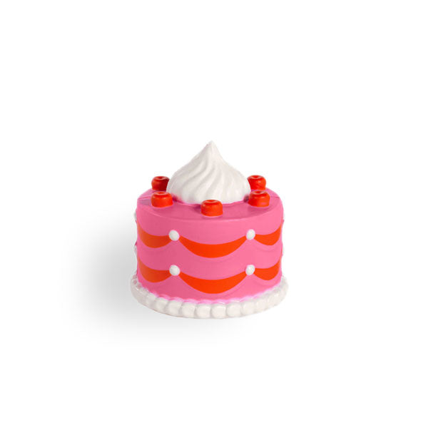 Foam toy resembles a pink cake with red and white frosting