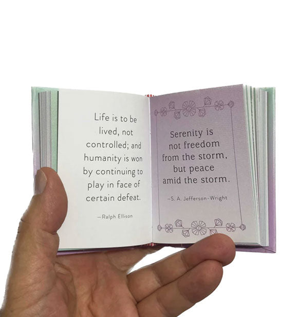 Model's hand holds open a tiny publication of a book printed with quotes by Ralph Ellison and S.A. Jefferson-Wright