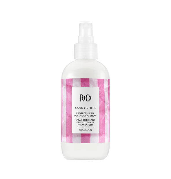 8.5 ounce bottle of R+Co Candy Stripe Protect + Prep Detangling Spray with pink and white stripe label design