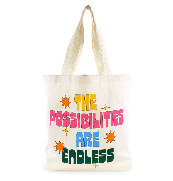 White canvas tote bag says, "The Possibilities Are Endless" in yellow, pink, blue, and dark green lettering accented by orange and yellow stars