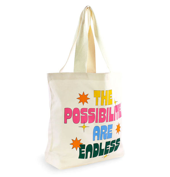 White canvas tote bag says, "The Possibilities Are Endless" in yellow, pink, blue, and dark green lettering accented by orange and yellow stars