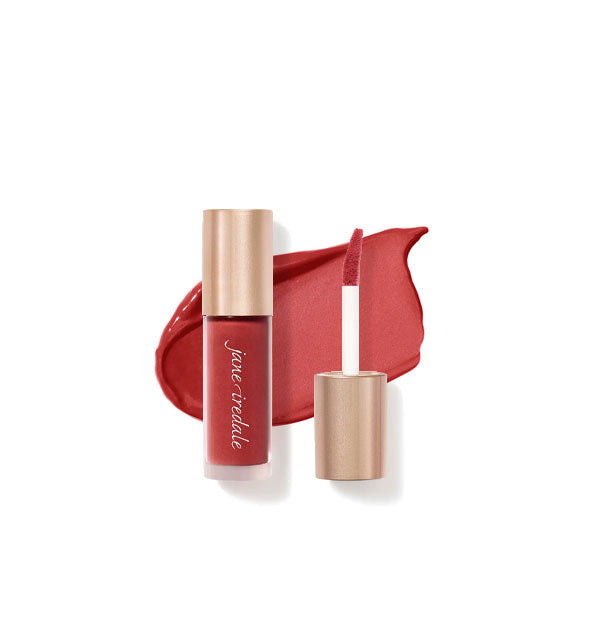 Tube of Jane Iredale Beyond Matte Lip Stain with separate gold doe foot applicator cap rest atop an enlarged sample application of product in shade Captivate