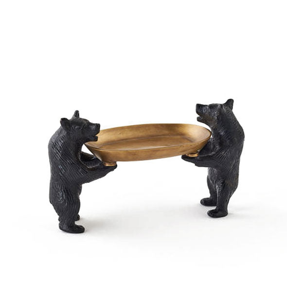 Soap dish consisting of two cast iron bear figurines on hind legs supporting a brass dish with their front paws