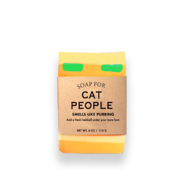 Bar of Soap for Cat People (Smells Like Purring) is yellow and gold with green flecks and wrapped in brown paper with black lettering