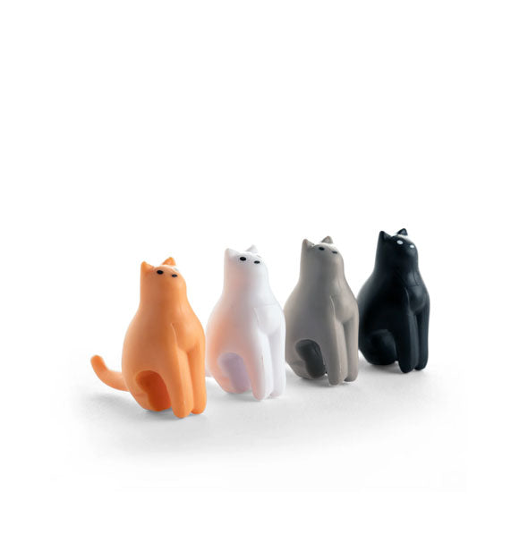 Set of four cat figurines in orange, white, gray, and black