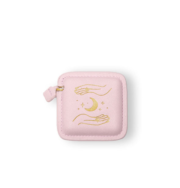 Square stitched light pink vegan leather measuring tape holster with pull tab features metallic gold foil hands, crescent moon, and stars artwork