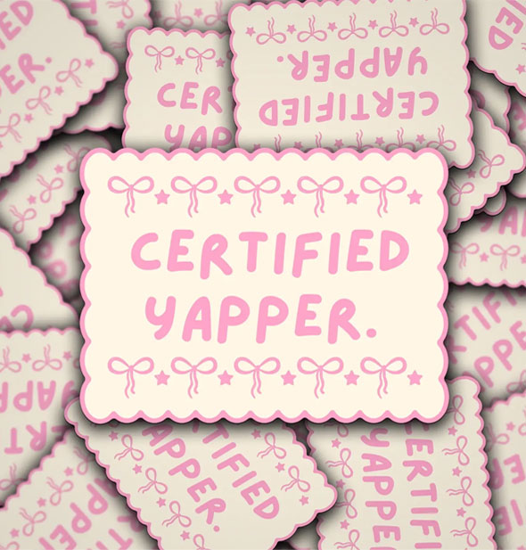 Smattering of rectangular stickers with scalloped, pink-bordered edges and pink bows say, "Certified Yapper" in pink lettering